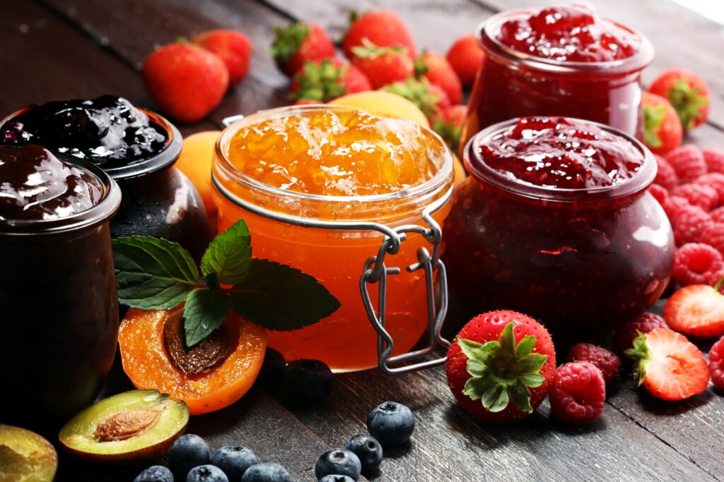 Assorted fruit products displayed with fresh berries and stone fruit